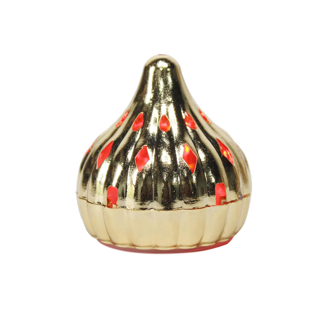 Hand holding a portable Modak LED light, highlighting its compact and safe design.