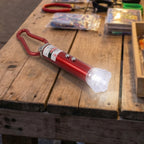 Close-up view of the compact 4-in-1 laser pointer showing its LED light.