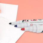 Set of three whiteboard markers with fine tips and a board eraser