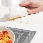A used kitchen cleaning wipe effectively removing stubborn oil stains from a counter.