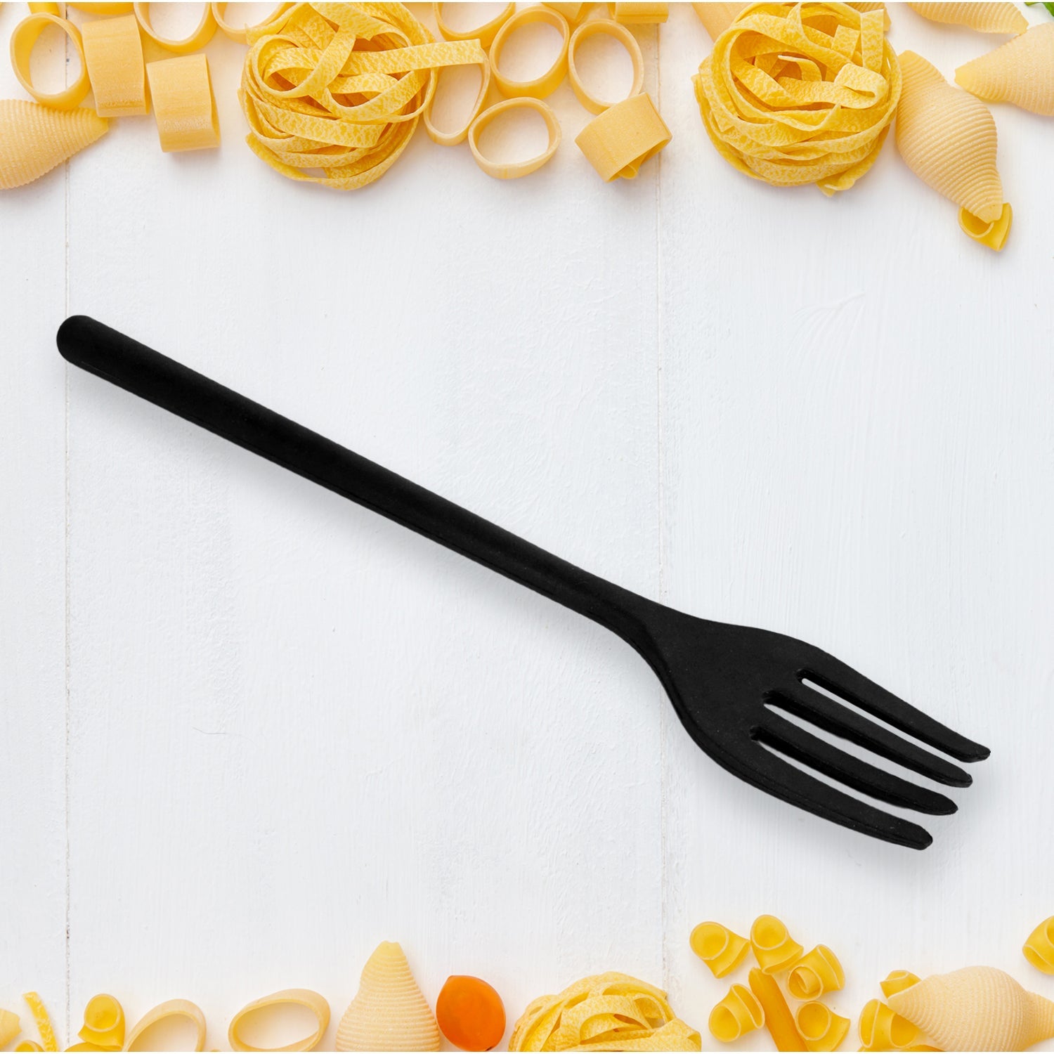 A yellow silicone cooking fork being used to stir food in a nonstick pan, illustrating its gentle use.