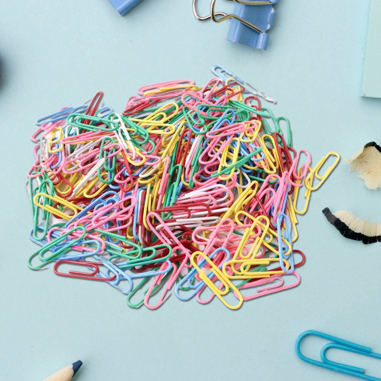 Assorted color paper clips arranged in a pile showing variety