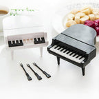 A child happily using the piano-shaped snack forks, making healthy eating fun and engaging.
