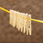 Sturdy bamboo wooden cloth clips with stainless steel springs, ready for household use.