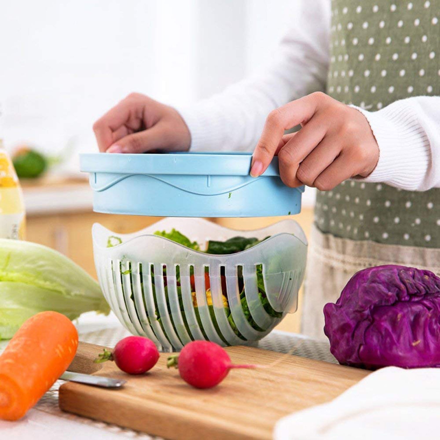 The ChopFresh 60 Seconds Bowl being used as a strainer to wash vegetables.