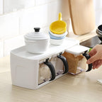 Modular spice storage box set with stand and measuring spoons on kitchen counter
