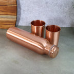 The 1000ml copper water bottle alongside two 300ml copper glasses, ready for daily hydration.