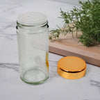 Rotating spice rack with clear glass jars and bright LED illumination in a kitchen.