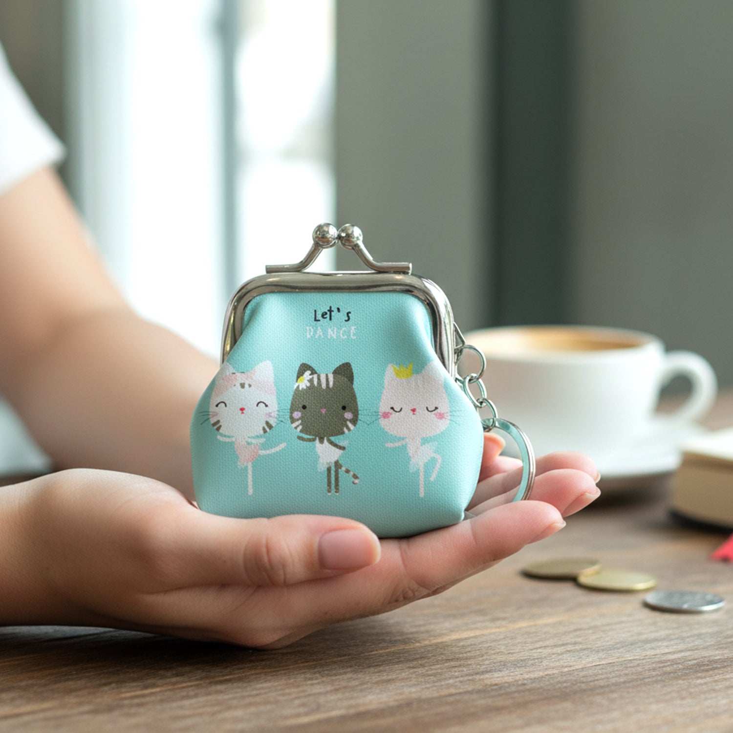 Portable coin pouch featuring cartoon cat print and metal clasp