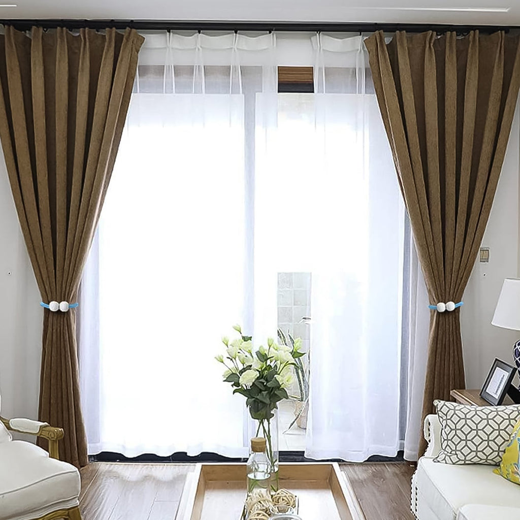 Magnetic curtain tieback twisted to adjust length on window curtain