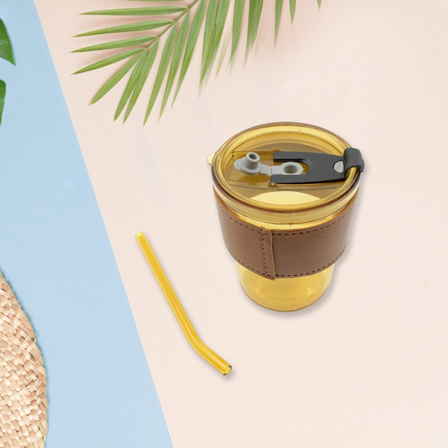 Convenient clear glass mug with a protective sleeve, straw, and leakproof lid.