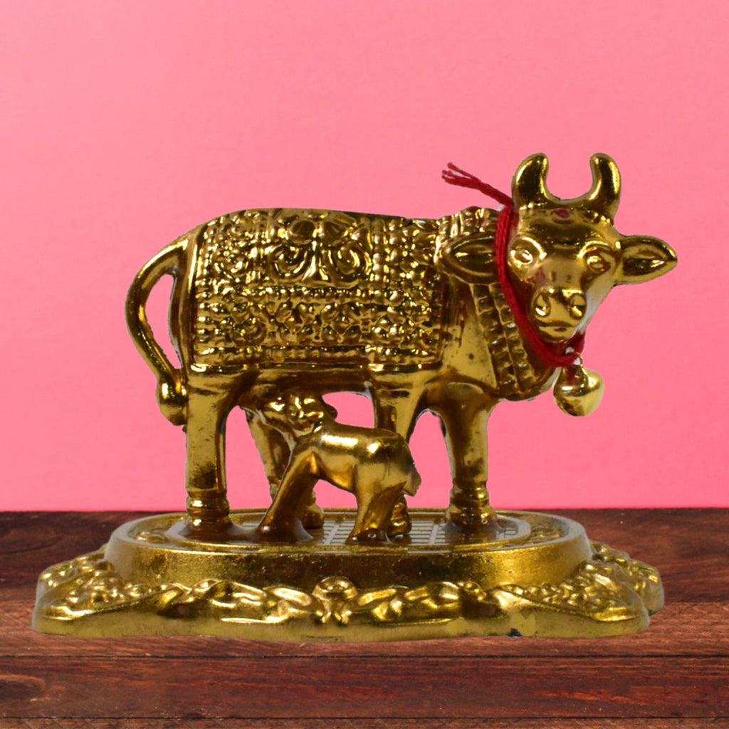 Sacred metal Kamdhenu Cow and calf idol in golden finish