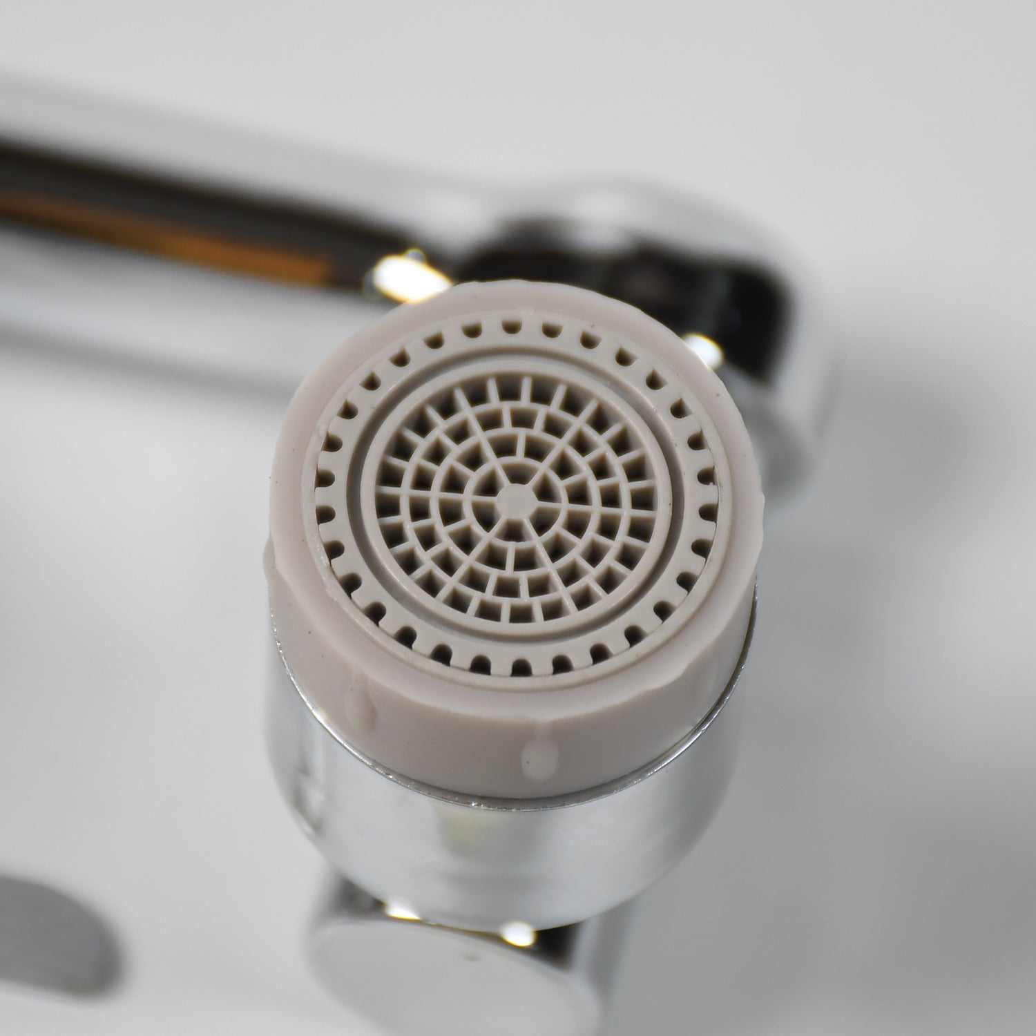 Close-up view of the faucet filter sprayer head, highlighting its dual water flow modes.