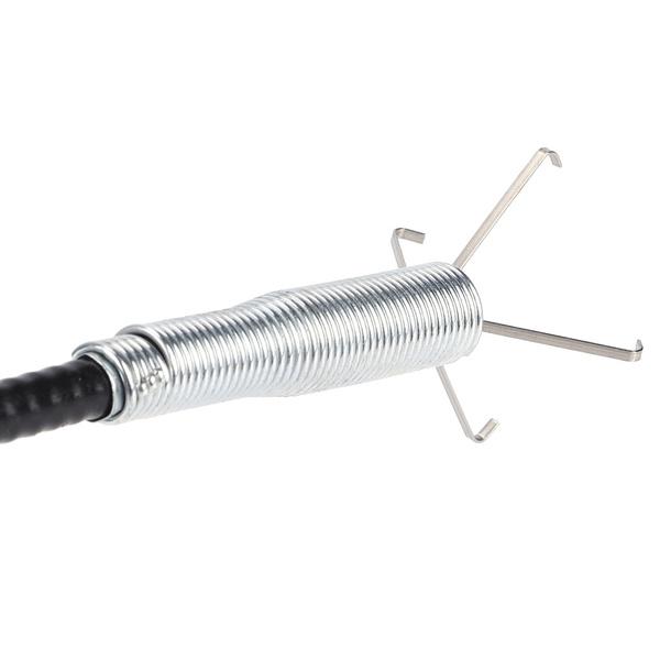 User demonstrating the flexible drain cleaning brush in a kitchen sink.