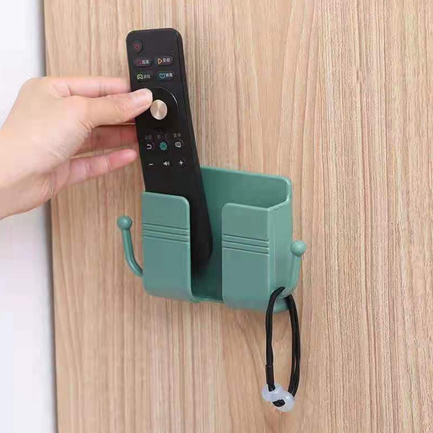 Compact wallmount mobile stand with integrated hook, holding a smartphone and keys.