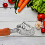 Close-up of sharp steel blade on vegetable peeler with wooden handle