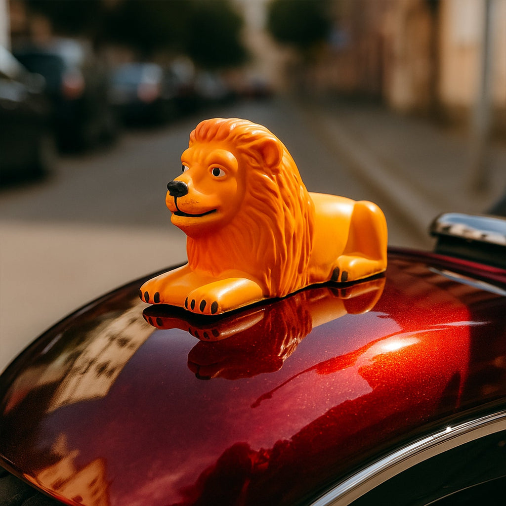 Orange-gold lion dashboard ornament enhancing car interior style