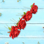 Various red rose bridal hair clips arranged, highlighting their versatile use.