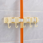 Close-up image of broom holder's multi-roller grip system on wall