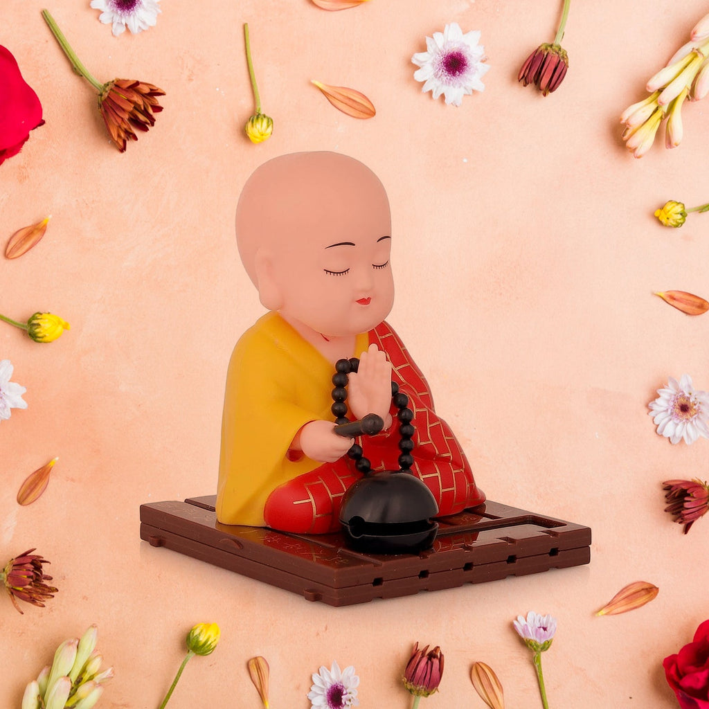 Close-up of red solar Buddha statue showing smooth movement