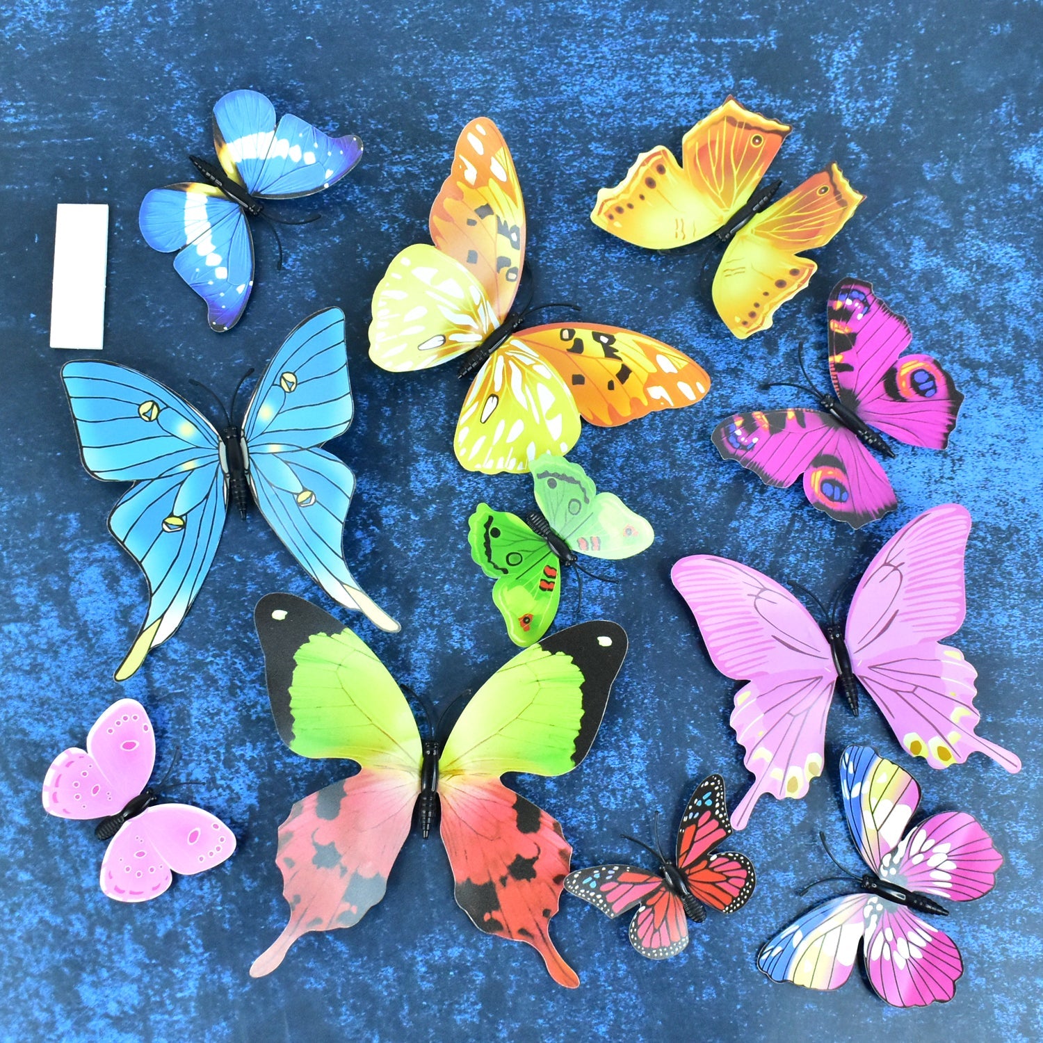Decorative 3D butterfly stickers arranged on white background