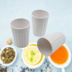 Reusable plastic coffee cups neatly stacked, highlighting their space-saving design.