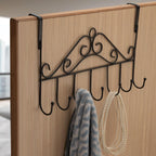 Over Door Hanger Rack holding various coats and bags, showcasing its storage capacity.