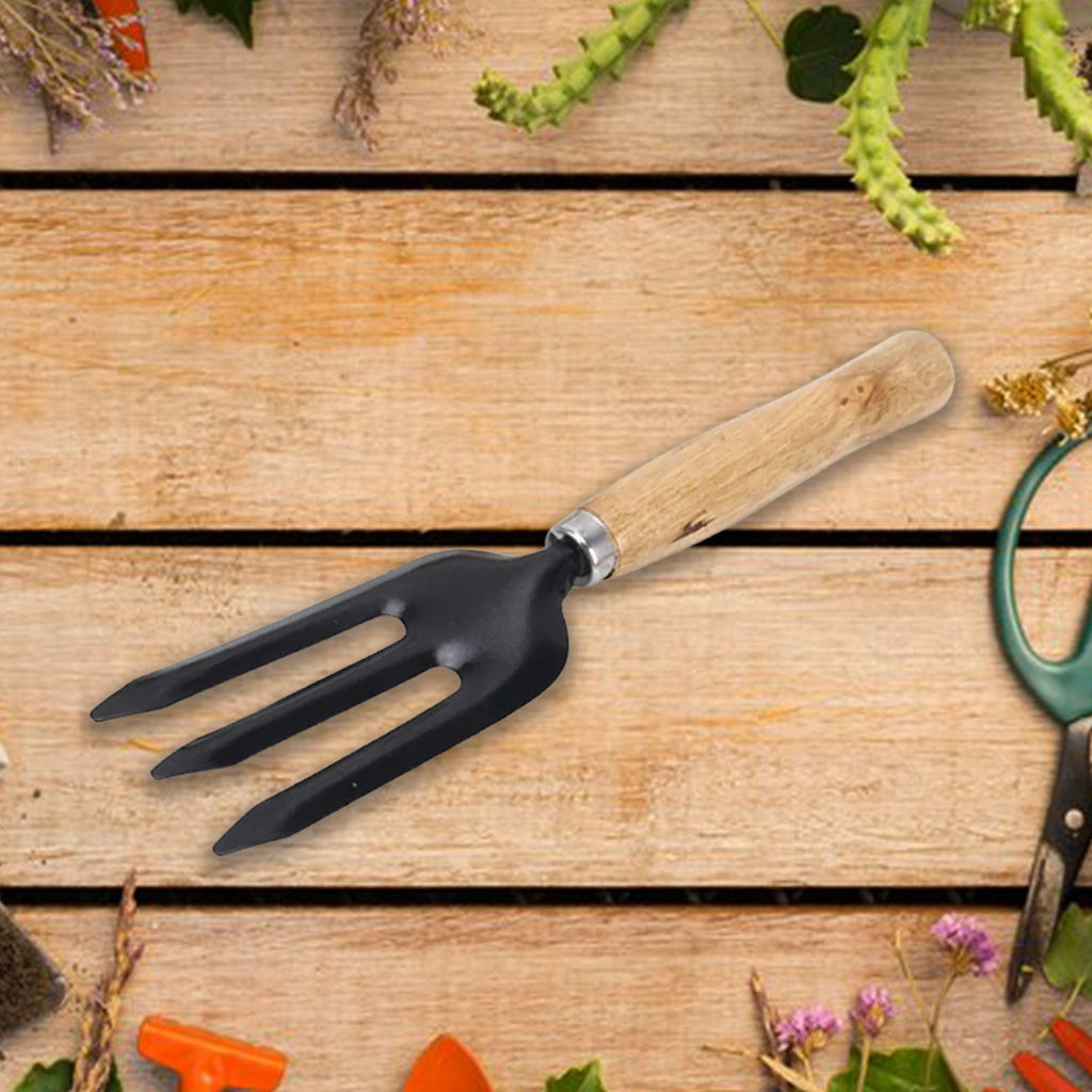 The versatile hand weeding fork posed in a garden bed, perfect for planting and transplanting.