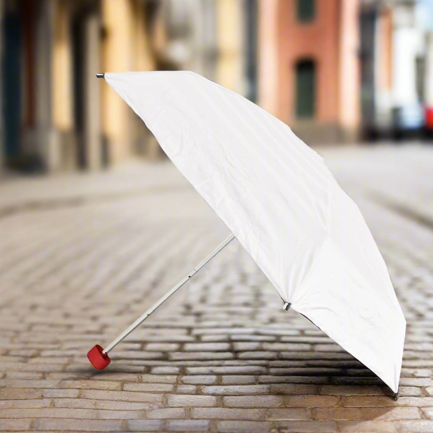 Compact DrizzlePro foldable umbrella closed, ready for travel.