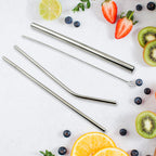 Assortment of straight and bent stainless steel straws displayed on a clean surface.