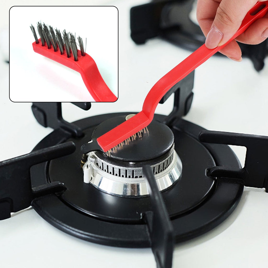 Angled mini wire brush effectively cleaning a tight corner on a metal surface.