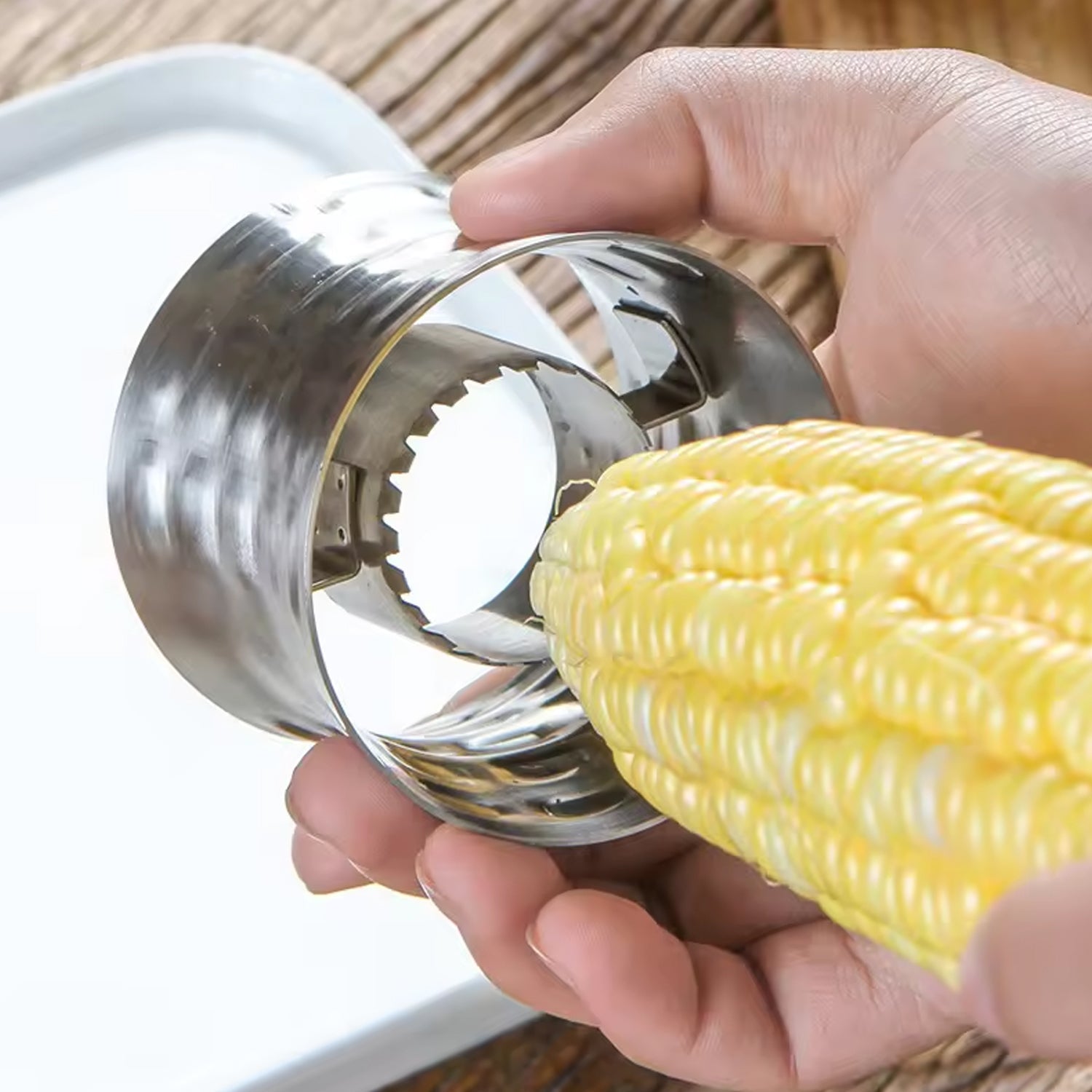 Detailed view of the sharp stainless steel blade on the corn kernel remover.