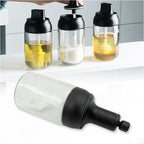 A Heat-Resistant Glass Seasoning Jar with integrated spoon, perfect for kitchen use.