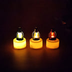 Elegant flameless LED candles with colorful lantern tops displayed in storage box
