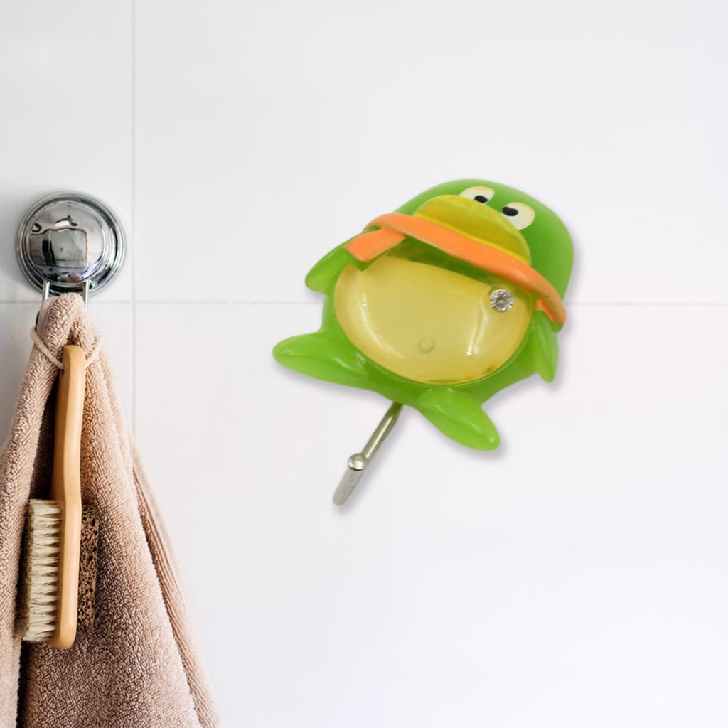 Multiple decorative self-adhesive wall hooks organizing kitchen utensils.