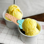 Ergonomic plastic ice cream scoop in green, showing the easy-release trigger mechanism.