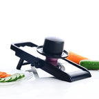 Multipurpose grater and slicer in action, preparing fresh vegetables for a meal.