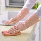 Durable natural gum rubber gloves protecting hands while cleaning a kitchen sink.