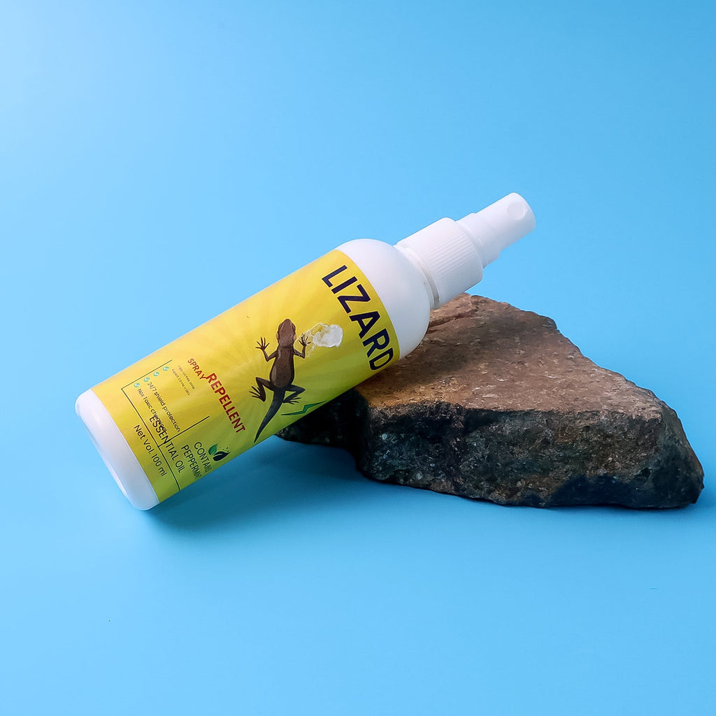 Close-up view of lizard repellent spray bottle showing herbal formula