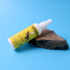 Close-up view of lizard repellent spray bottle showing herbal formula