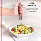 Two thumb press grinders, one for salt and one for pepper, on a table.