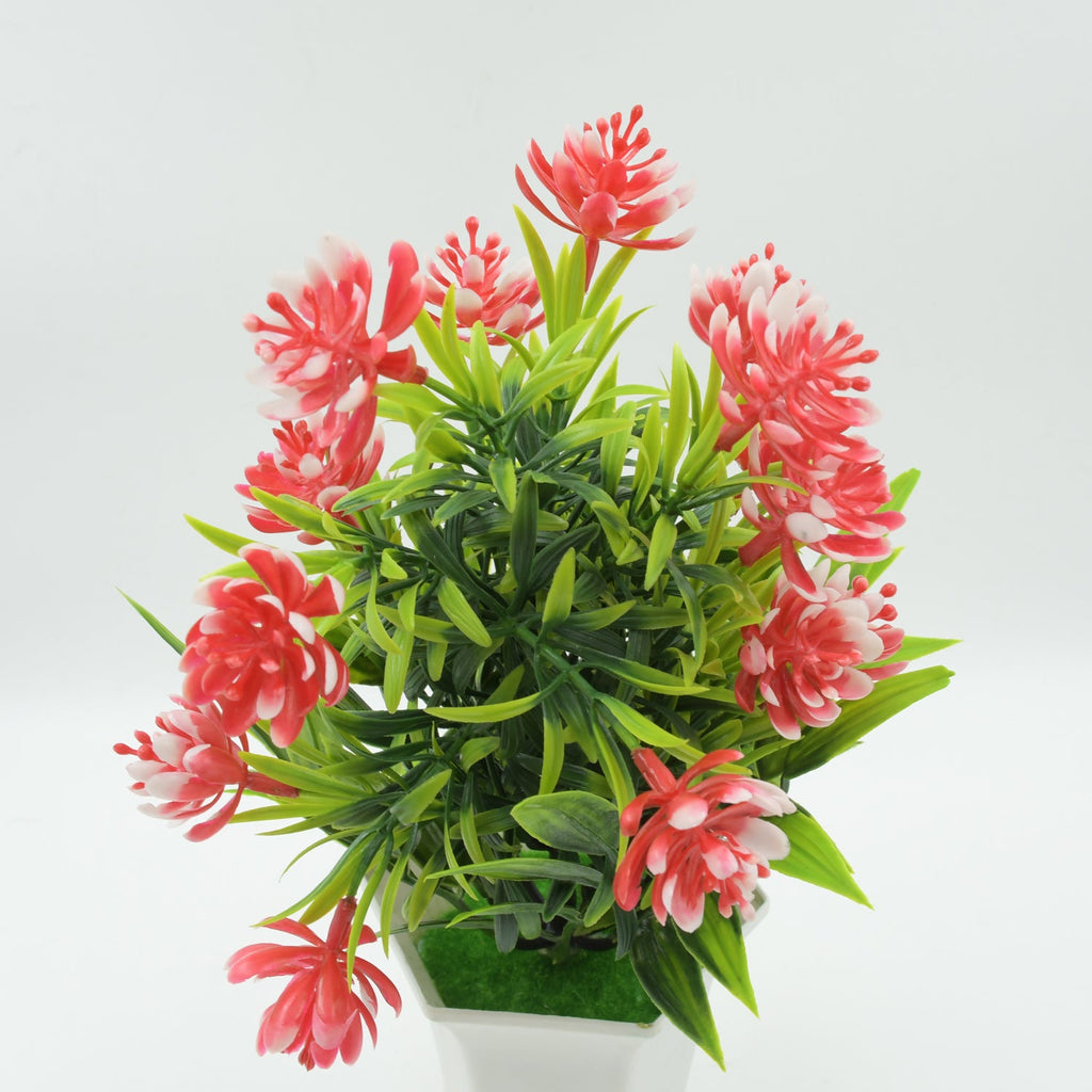 Close-up of the artificial flower plant's vibrant pink flowers and detailed green foliage.