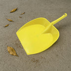 Side view of the sturdy long handle dustpan construction.
