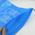 Hand holding the compact folded Organivo waterproof storage bag, emphasizing ease of carrying.