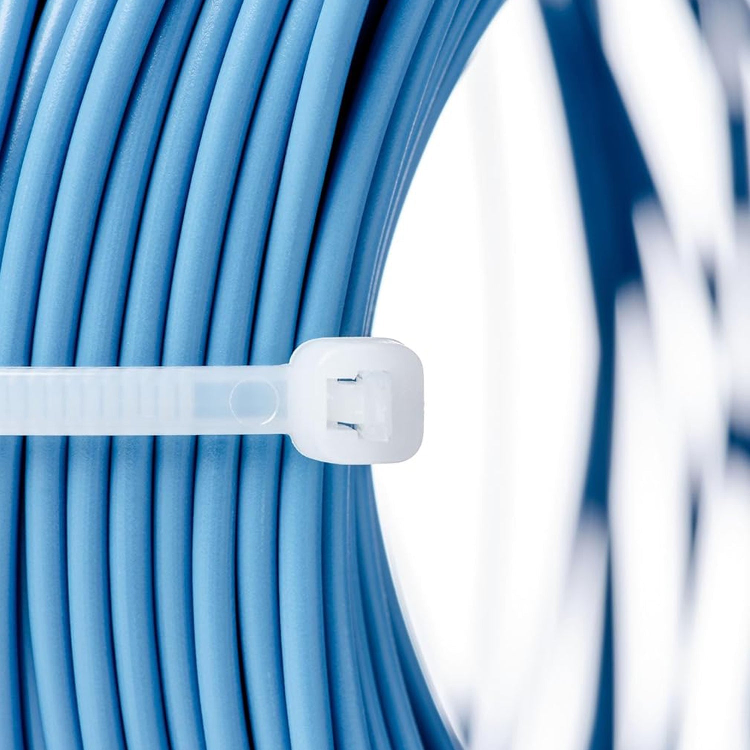 Three black 10-inch nylon zip ties laid out, highlighting their uniform length and robust design.