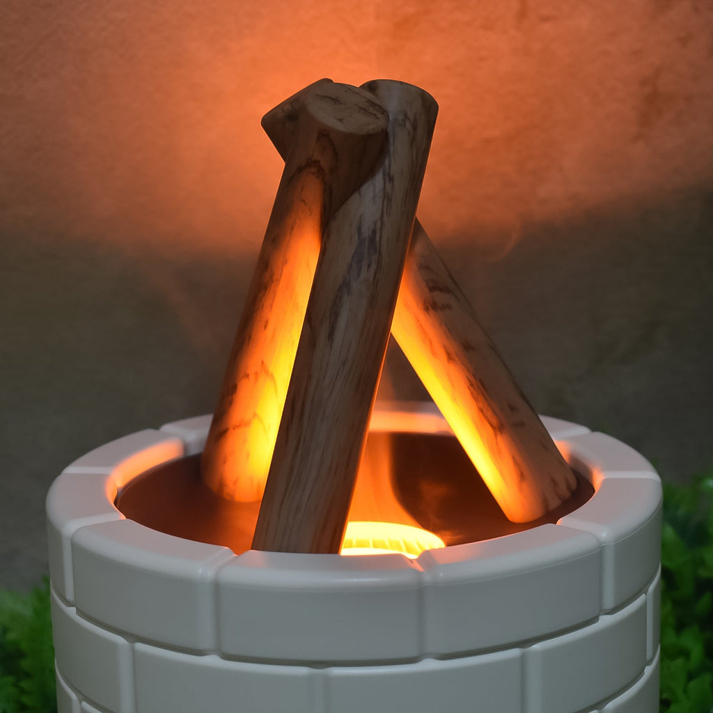 Compact essential oil diffuser with simulated flame and mist, shown in a contemporary interior.