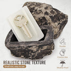 A standard house key discreetly hidden inside the fake rock key hider.