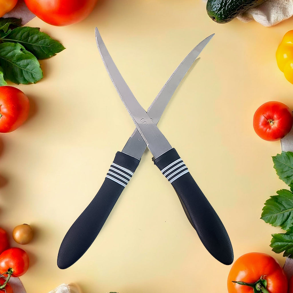 Two curved serrated kitchen knives with ergonomic black handles arranged on surface