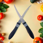 Two curved serrated kitchen knives with ergonomic black handles arranged on surface