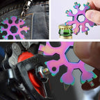Snowflake Multi-Tool in a person's hand, showcasing its compact size and design.
